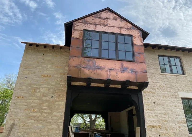 Copper metal panel facade on a stone building for Skylight Installation in Cedarburg