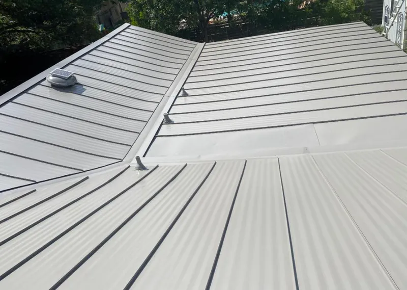 Solar attic fan installed on a metal roof for Roof Ventilation in Cedarburg