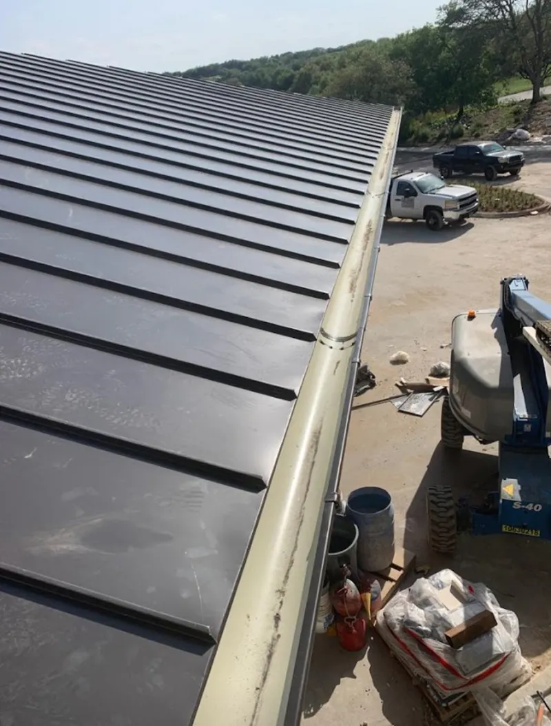 Standing seam panel and gutter detail on a metal roofing jobsite in Cedarburg